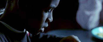 Movie still from “Ballast” (2008), directed by Lance Hammer – A person's face in a dimly - lit room; Extreme Close Up shot, High angle