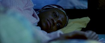 Movie still from “Ballast” (2008), directed by Lance Hammer – A person laying in a bed; Close Up shot, High angle