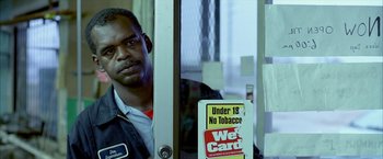 Movie still from “Ballast” (2008), directed by Lance Hammer – A man standing in front of a store window; Close Up shot, Low angle