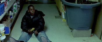 Movie still from “Ballast” (2008), directed by Lance Hammer – A young boy sitting on the floor of a room; Medium shot, High angle