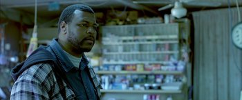 Movie still from “Ballast” (2008), directed by Lance Hammer – A man standing in front of a shelf in a store; Close Up shot, Over the shoulder angle