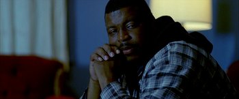 Movie still from “Ballast” (2008), directed by Lance Hammer – A person with his hand on his chin; Close Up shot, Low angle