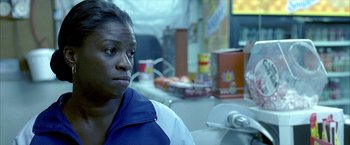 Movie still from “Ballast” (2008), directed by Lance Hammer – A woman in a blue and white jacket looking at the camera; Close Up shot, Over the shoulder angle