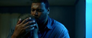 Movie still from “Ballast” (2008), directed by Lance Hammer – A man is kissing a woman on the cheek; Close Up shot, Over the shoulder angle