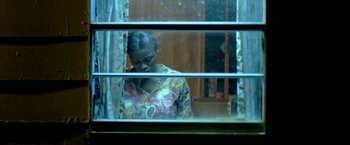 Movie still from “Ballast” (2008), directed by Lance Hammer – A woman looking out of a window at night; Close Up shot, High angle