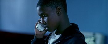 Movie still from “Ballast” (2008), directed by Lance Hammer – A young man talking on a cell phone; Close Up shot, High angle