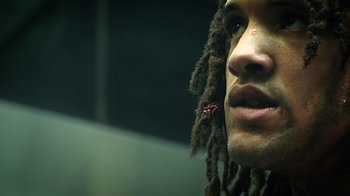 Movie still from “Bamboozled” (2000), directed by Spike Lee – A person with dreadlocks; Extreme Close Up shot, Low angle
