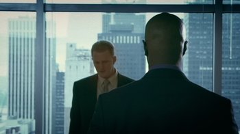 Movie still from “Bamboozled” (2000), directed by Spike Lee – Two men in suits are looking at each other in a mirror; Medium shot, Over the shoulder angle