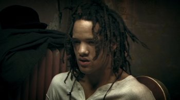 Movie still from “Bamboozled” (2000), directed by Spike Lee – A man with dreadlocks is looking at the camera; Close Up shot, High angle