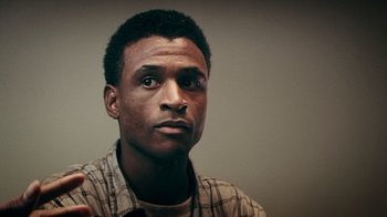 Movie still from “Bamboozled” (2000), directed by Spike Lee – A person wearing a plaid shirt; Close Up shot, Low angle