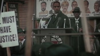 Movie still from “Bamboozled” (2000), directed by Spike Lee – A man is speaking at an african - american convention; Medium shot, Low angle