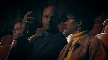 Movie still from “Bamboozled” (2000), directed by Spike Lee – A man and a woman sitting next to each other; Close Up shot, Low angle