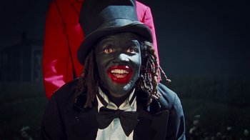 Movie still from “Bamboozled” (2000), directed by Spike Lee – A man in a top hat and a black suit; Close Up shot, High angle