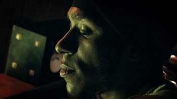 Movie still from “Bamboozled” (2000), directed by Spike Lee – A man's face in the dark; Extreme Close Up shot, Low angle
