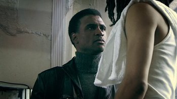 Movie still from “Bamboozled” (2000), directed by Spike Lee – A man and a woman standing next to each other in a room; Close Up shot, Low angle