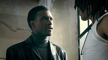 Movie still from “Bamboozled” (2000), directed by Spike Lee – A man in a leather jacket looking at another man in a leather jacket; Close Up shot, Low angle