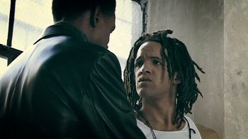 Movie still from “Bamboozled” (2000), directed by Spike Lee – A man standing next to another man with dreadlocks; Close Up shot, Over the shoulder angle