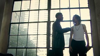 Movie still from “Bamboozled” (2000), directed by Spike Lee – A man and a woman standing in front of a window; Medium shot, Low angle