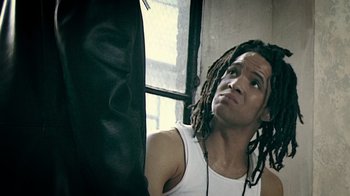 Movie still from “Bamboozled” (2000), directed by Spike Lee – A person with dreads; Close Up shot, Low angle
