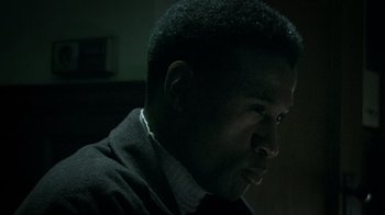 Movie still from “Bamboozled” (2000), directed by Spike Lee – A person wearing a suit and tie; Close Up shot, Low angle