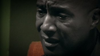 Movie still from “Bamboozled” (2000), directed by Spike Lee – A man's face with tears in his eyes; Extreme Close Up shot, High angle