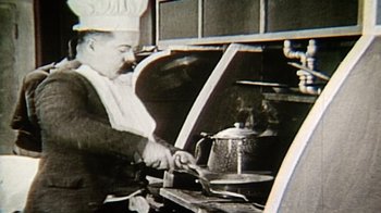Movie still from “Bamboozled” (2000), directed by Spike Lee – An old photo of a man cooking in an oven; Extreme Close Up shot, Low angle