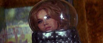 Movie still from “Barbarella” (1968), directed by Roger Vadim – A beautiful woman with red hair in a space helmet; Close Up shot, Low angle