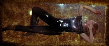 Movie still from “Barbarella” (1968), directed by Roger Vadim – A woman in a black catsuit laying on the floor; Medium shot, Overhead angle