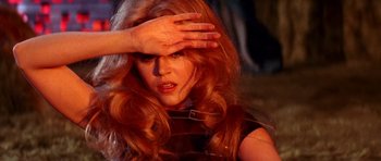 Movie still from “Barbarella” (1968), directed by Roger Vadim – A woman with long red hair covering her face; Close Up shot, High angle