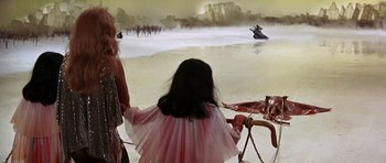Movie still from “Barbarella” (1968), directed by Roger Vadim – A woman and a little girl in a pink dress; Wide shot, High angle