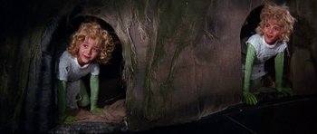 Movie still from “Barbarella” (1968), directed by Roger Vadim – A young child is hiding in a cave; Medium shot, High angle