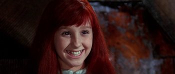 Movie still from “Barbarella” (1968), directed by Roger Vadim – A young girl with red hair smiling for the camera; Close Up shot, High angle