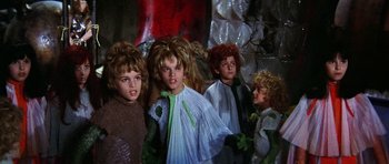 Movie still from “Barbarella” (1968), directed by Roger Vadim – A group of young girls standing next to each other; Medium shot, High angle