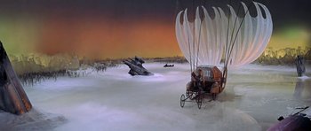 Movie still from “Barbarella” (1968), directed by Roger Vadim – An artistic rendering of an old fashioned carriage in the middle of a snowy field; Extreme Wide shot, High angle