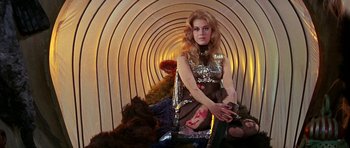 Movie still from “Barbarella” (1968), directed by Roger Vadim – A woman sitting in the middle of a tunnel; Medium shot, High angle