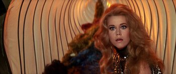 Movie still from “Barbarella” (1968), directed by Roger Vadim – A person with long blonde hair; Close Up shot, Over the shoulder angle