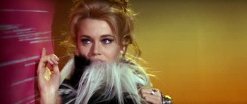 Movie still from “Barbarella” (1968), directed by Roger Vadim – A person wearing a fur coat; Close Up shot, Over the shoulder angle