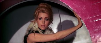 Movie still from “Barbarella” (1968), directed by Roger Vadim – A beautiful woman with long blonde hair wearing a fur coat; Close Up shot, Low angle