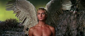 Movie still from “Barbarella” (1968), directed by Roger Vadim – A shirtless man with a large angel wings; Close Up shot, Low angle