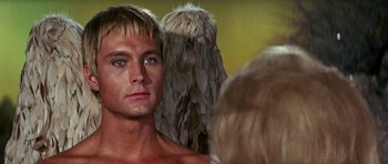 Movie still from “Barbarella” (1968), directed by Roger Vadim – A man looking into a mirror in front of a woman; Close Up shot, Over the shoulder angle