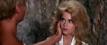 Movie still from “Barbarella” (1968), directed by Roger Vadim – A person holding their hand to her face; Close Up shot, Over the shoulder angle