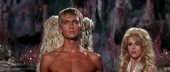 Movie still from “Barbarella” (1968), directed by Roger Vadim – A shirtless man with wings in front of a wall; Close Up shot, Low angle
