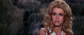 Movie still from “Barbarella” (1968), directed by Roger Vadim – A person with long blonde hair; Close Up shot, Low angle
