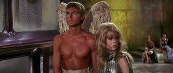 Movie still from “Barbarella” (1968), directed by Roger Vadim – A man and a woman dressed like angels; Medium shot, Low angle