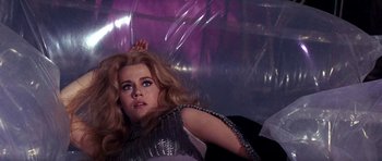 Movie still from “Barbarella” (1968), directed by Roger Vadim – A person wearing a dress; Medium shot, Low angle