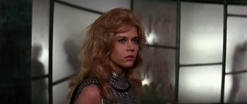 Movie still from “Barbarella” (1968), directed by Roger Vadim – A woman with long blonde hair wearing a chain mail outfit; Close Up shot, Low angle