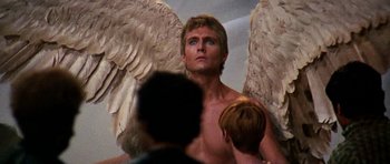 Movie still from “Barbarella” (1968), directed by Roger Vadim – A man with wings on his back; Close Up shot, Low angle