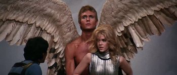 Movie still from “Barbarella” (1968), directed by Roger Vadim – A man and a woman are standing next to each other; Medium shot, Low angle