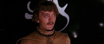 Movie still from “Barbarella” (1968), directed by Roger Vadim – A person wearing a collar with a chain around the neck; Close Up shot, Low angle