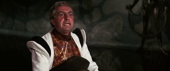 Movie still from “Barbarella” (1968), directed by Roger Vadim – A person wearing a suit and tie; Close Up shot, Low angle